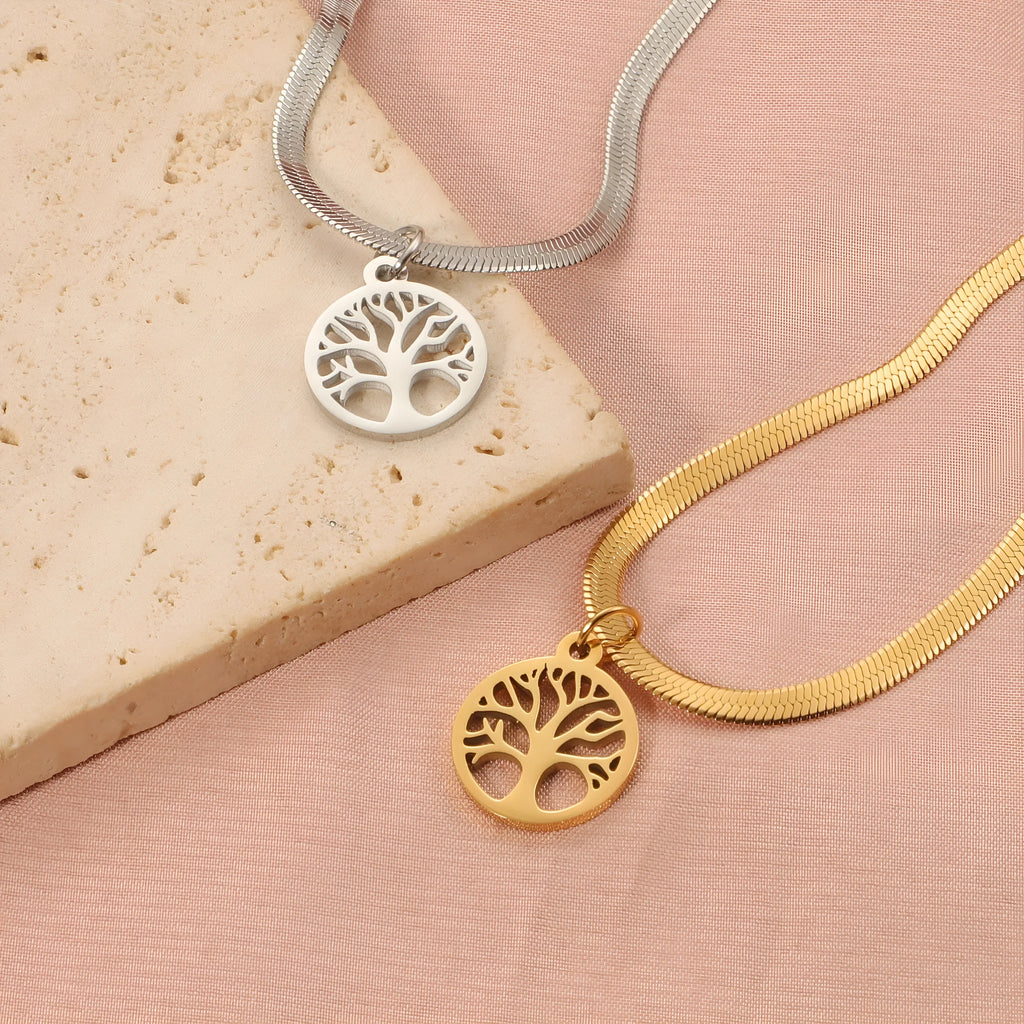 Stainless steel lucky tree pendant necklace on a snake bones chain, shown in gold and steel colour options.