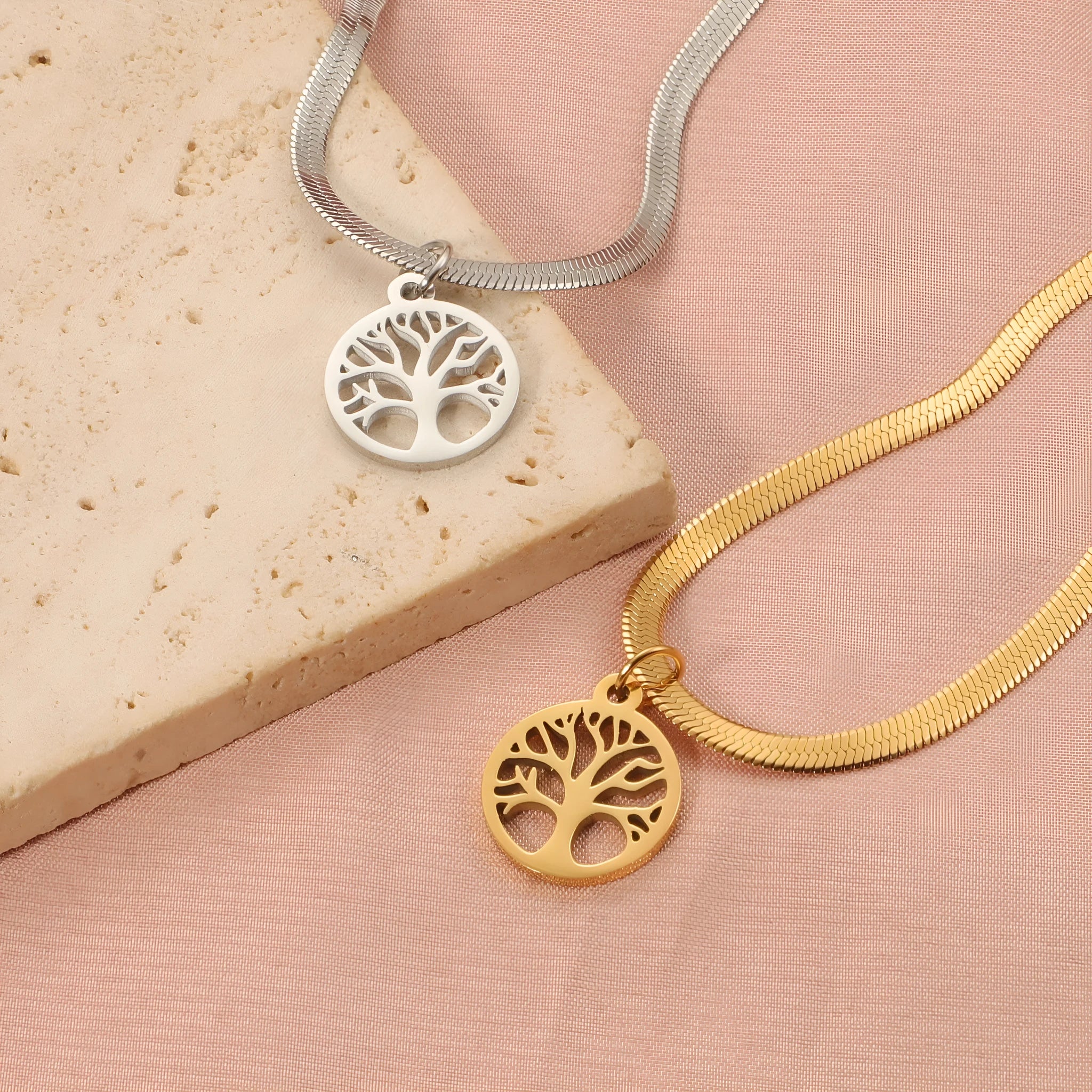 Stainless steel lucky tree pendant necklace on a snake bones chain, shown in gold and steel colour options.