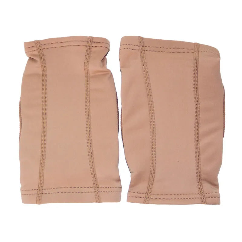 A pair of black knee pads for ballet dance and yoga exercise on a grey background.