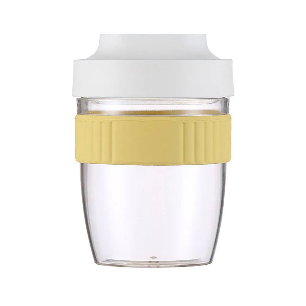Green plastic salad cup with clear lid and white spoon on a table