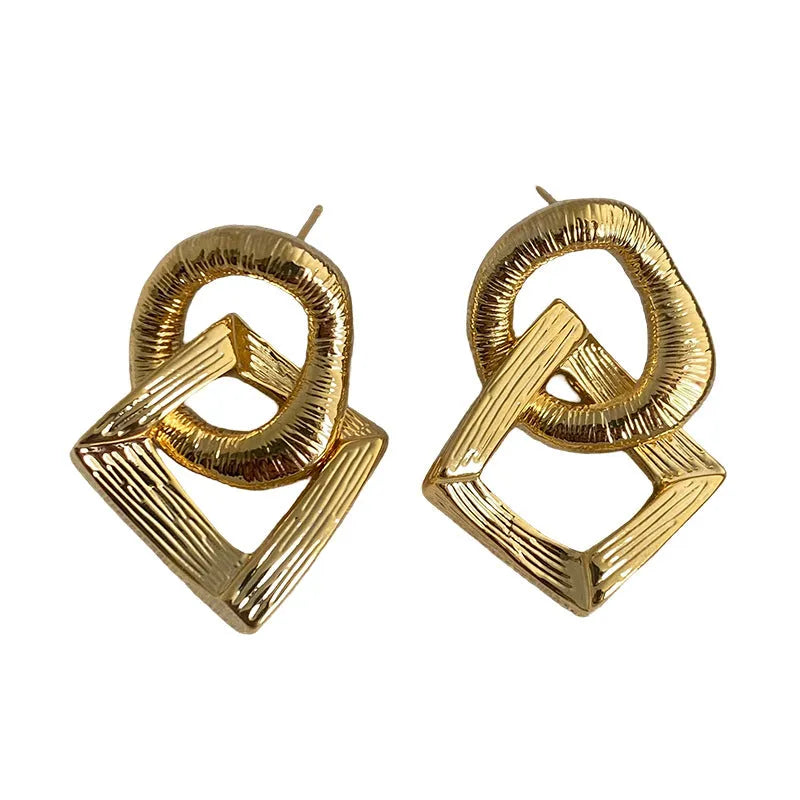 Retro geometric circle pendant earrings in gold or silver, made from copper with a 3.4cm drop.