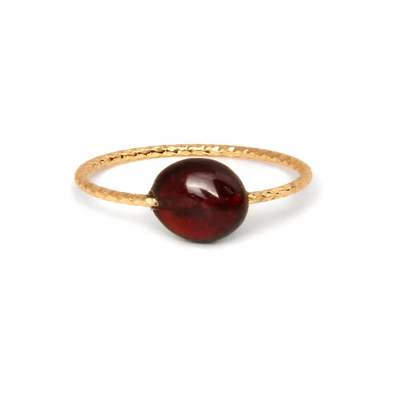 Geometric silver-toned ring setting with a central oval of blue and white banded agate stone on a woman's hand.