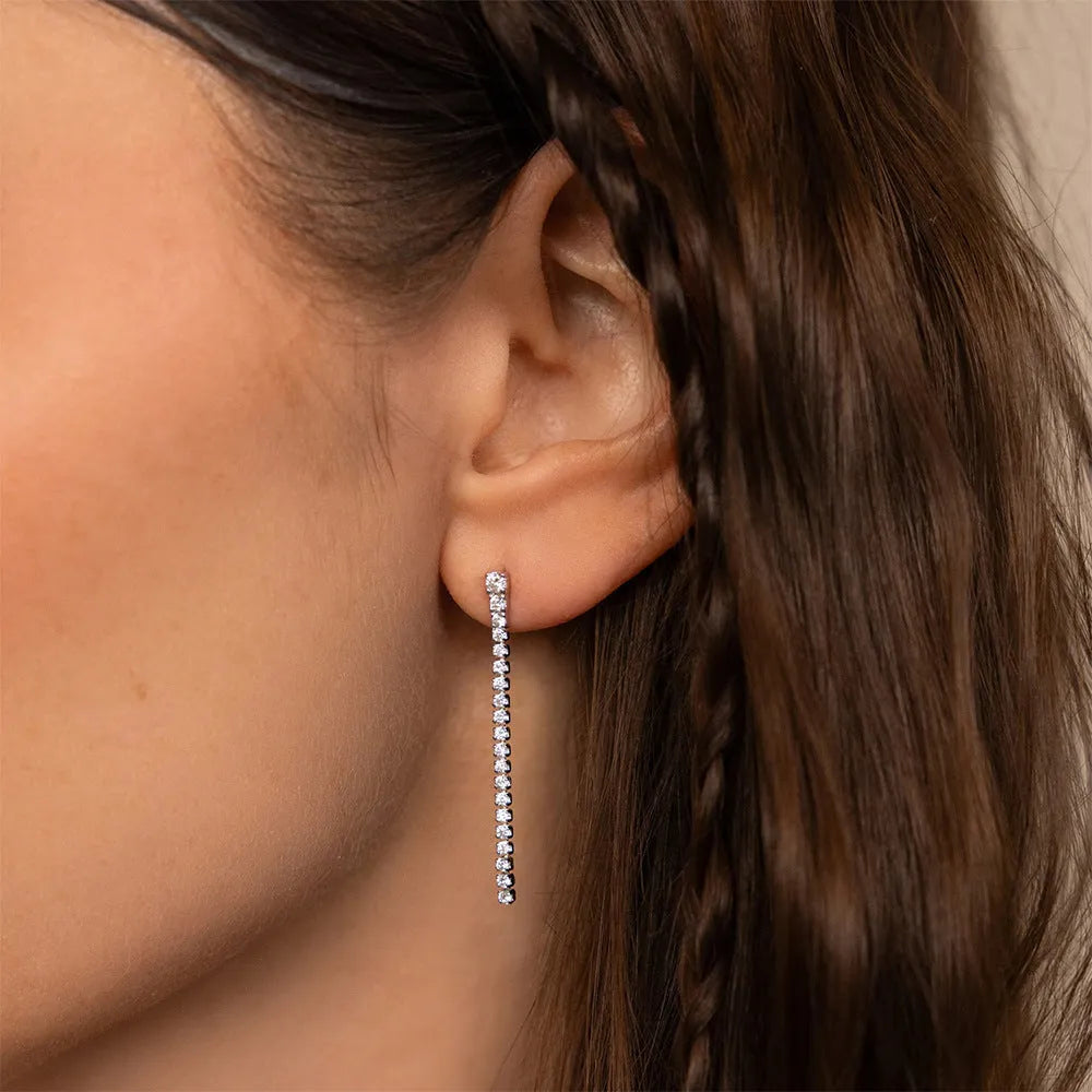 Geometric line pattern stainless steel stud earrings with zircon stones in gold colour.