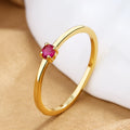 A personalised simple single diamond fine circle ring for women, made from copper, shown in a geometric round design.