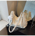 Women's soft PU backpack in neutral colours with pendant accessory