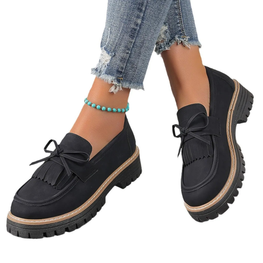 Black plus size women's loafers with a tassel and bowknot on a low-top PU upper.