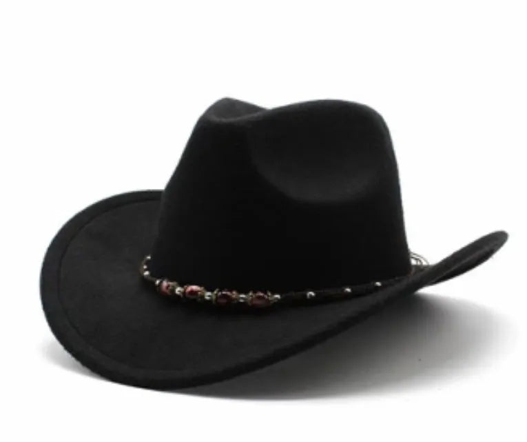 Brown leather velvet curved edge Western cowboy hat with a conical crown on a wooden surface.