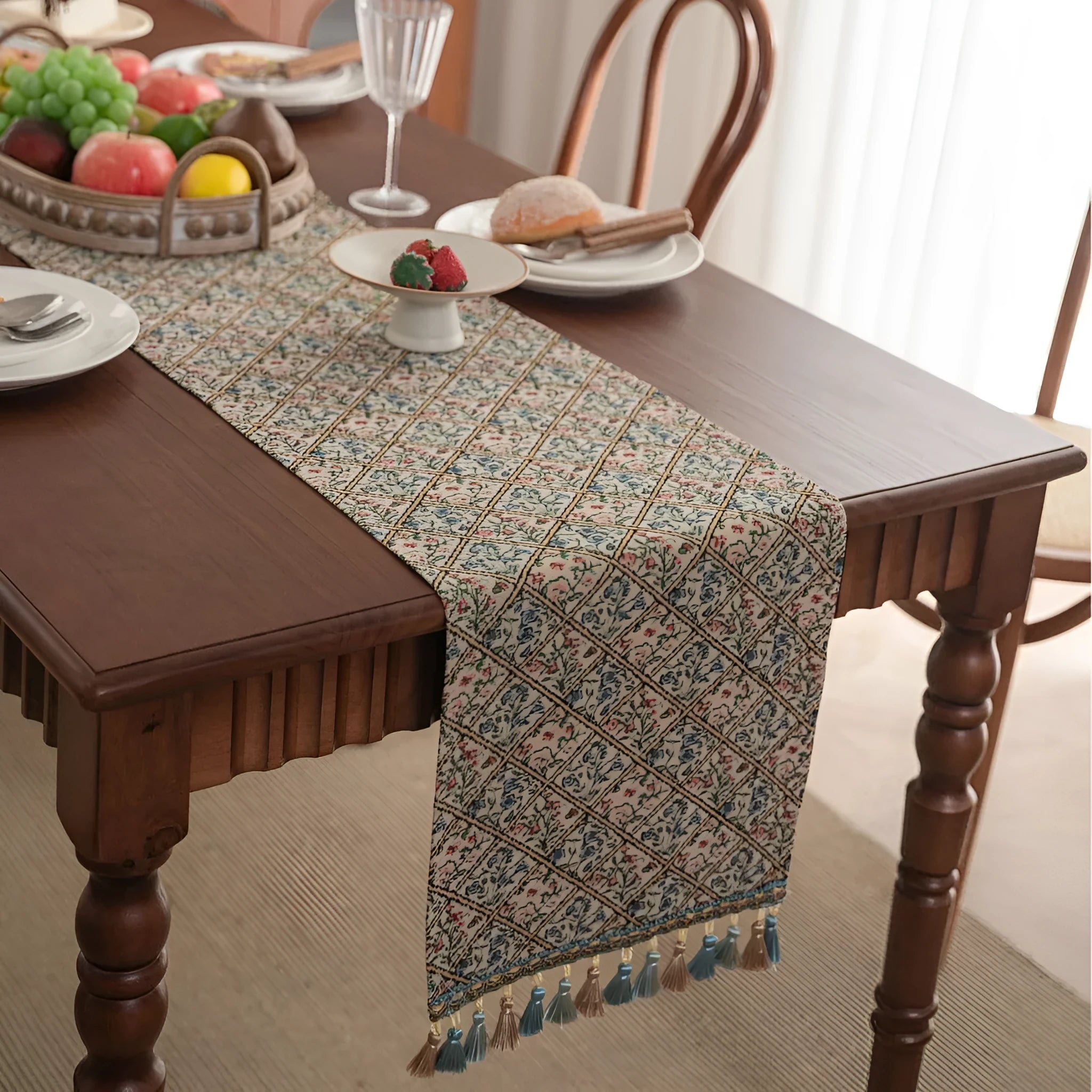 Dark blue striped jacquard table runner with tassel trim laid on a wooden table