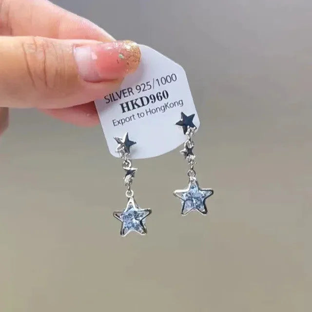 Geometric star and tassel design ear clips with rhinestone and heart details for women.