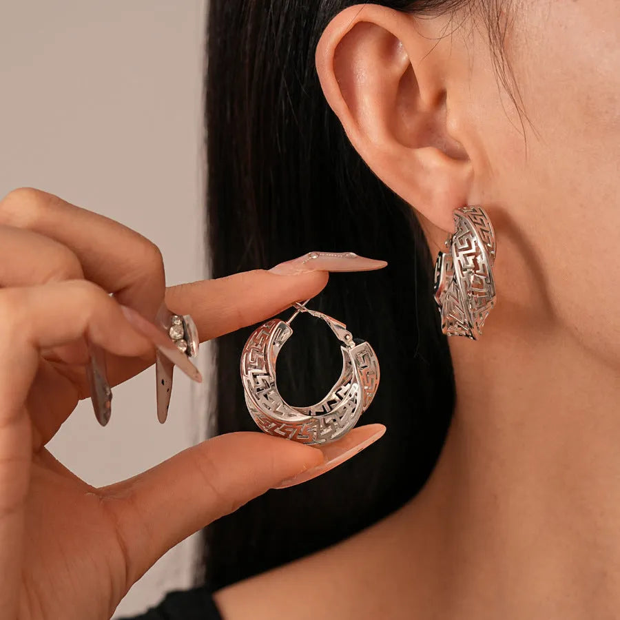 Gold and silver geometric women's hollow stud earrings with a twisted round design.
