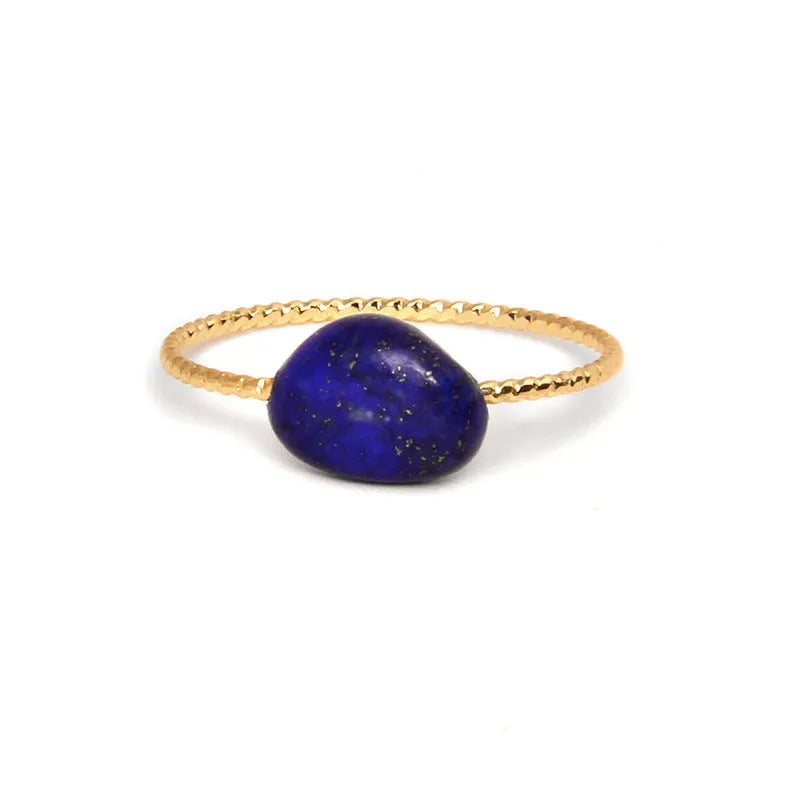 Geometric silver-toned ring setting with a central oval of blue and white banded agate stone on a woman's hand.