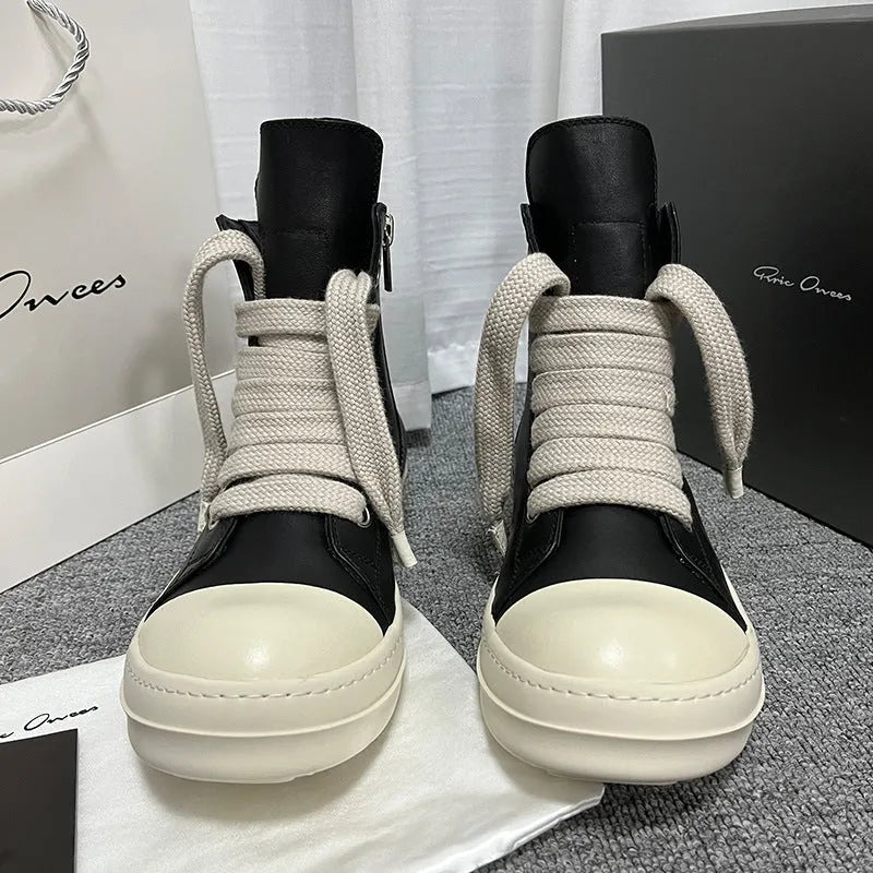 Black high-top leather shoes with a side zip and round toe on a rubber sole.
