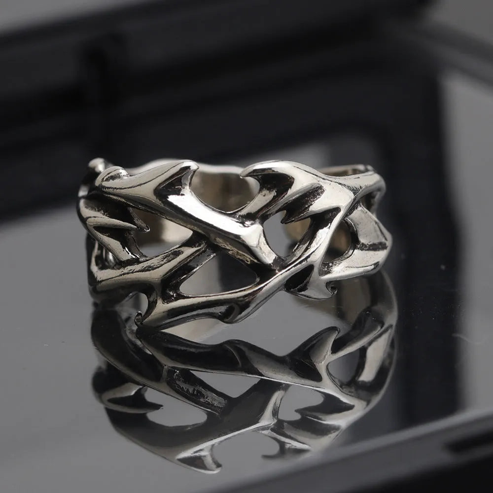 Adjustable copper men's ring with geometric thorn and flower design.