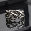 Adjustable copper men's ring with geometric thorn and flower design.