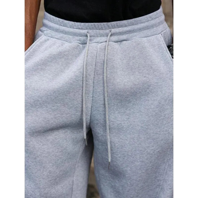Man wearing dark grey high-waisted straight-leg cropped casual trousers made from bamboo fibre.