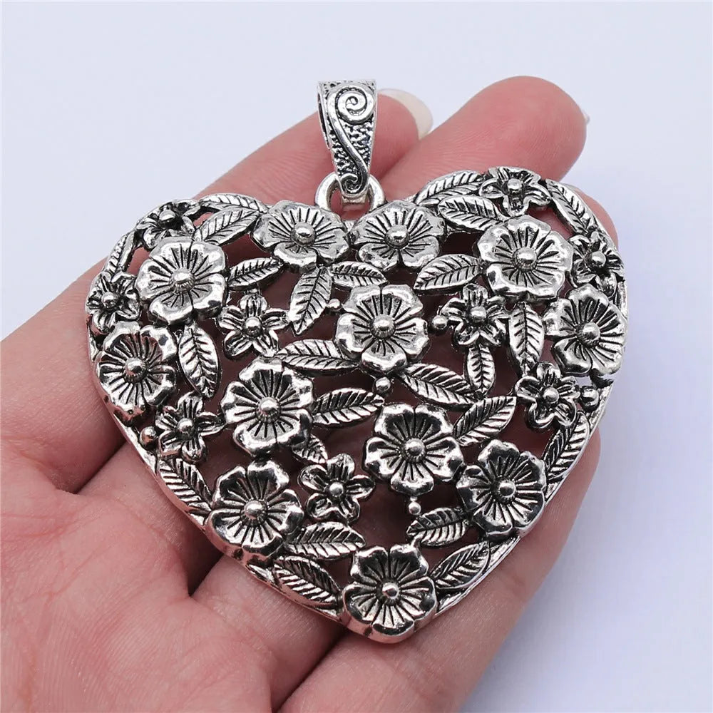 Ancient silver hollow flower love pendant measuring 67mm by 58mm with electroplated finish