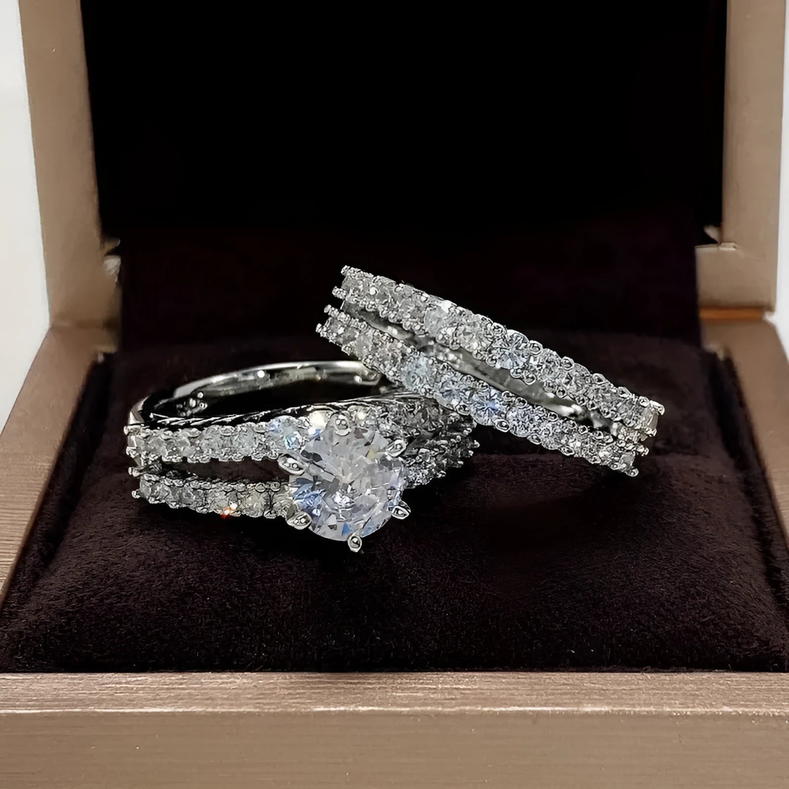 Two-ring women's set showing jewelled and geometric designs in silver, gold, and rose gold alloy