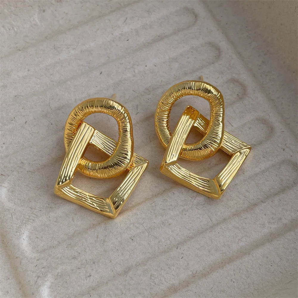 Retro geometric circle pendant earrings in gold or silver, made from copper with a 3.4cm drop.