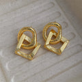 Retro geometric circle pendant earrings in gold or silver, made from copper with a 3.4cm drop.