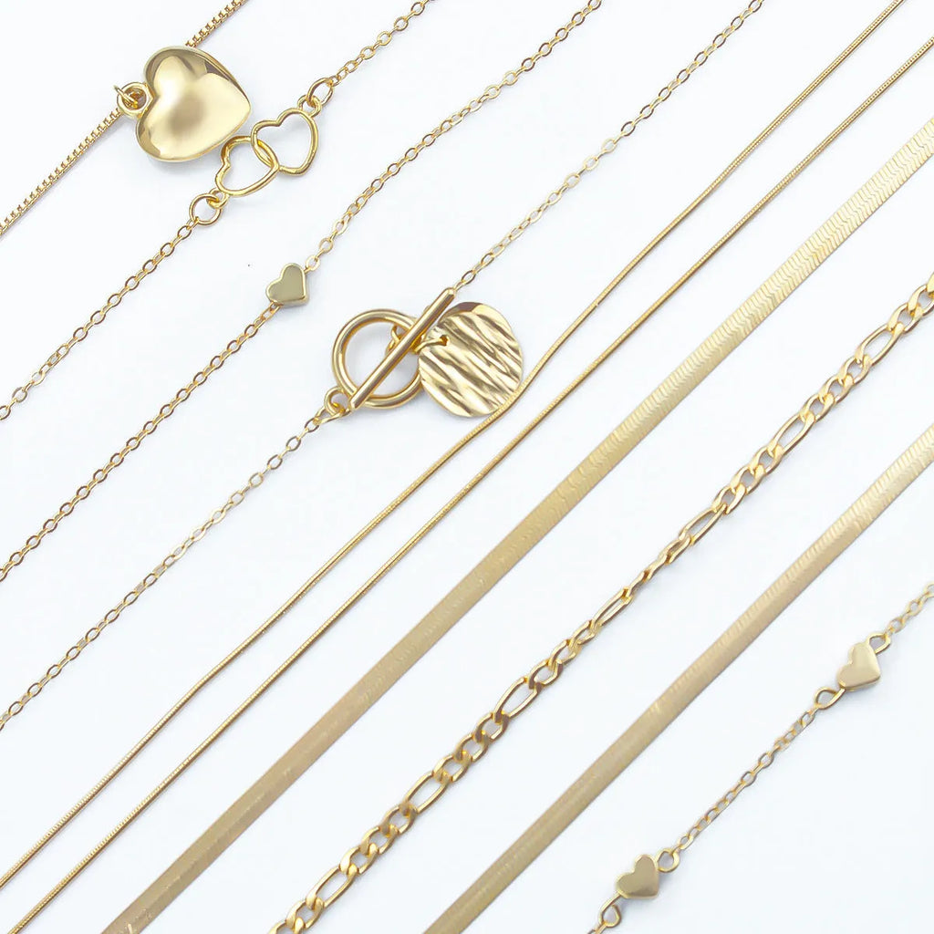 Set of ten gold-coloured women's necklaces with snake bones chains and alloy pendants.