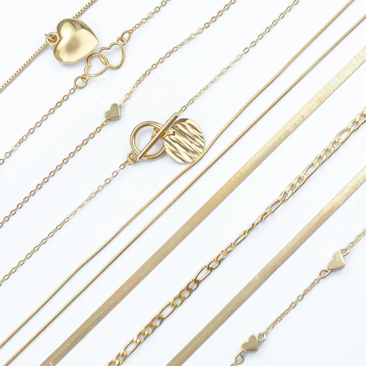Set of ten gold-coloured women's necklaces with snake bones chains and alloy pendants.