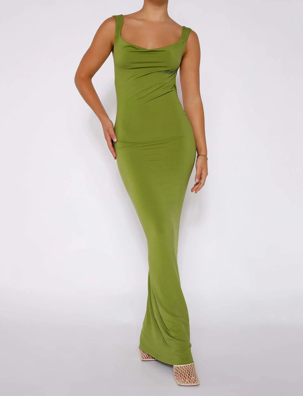 Backless milk silk sling dress in champagne colour on a model, showing slim fit and spaghetti straps.