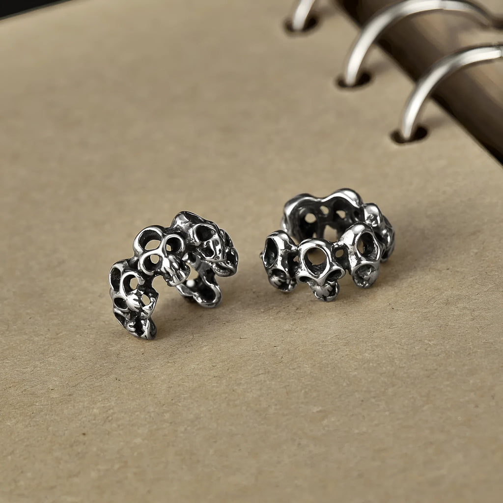 Stainless steel skull earrings with hollow geometric design and ear clip closure