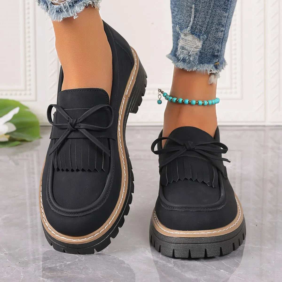 Black plus size women's loafers with a tassel and bowknot on a low-top PU upper.