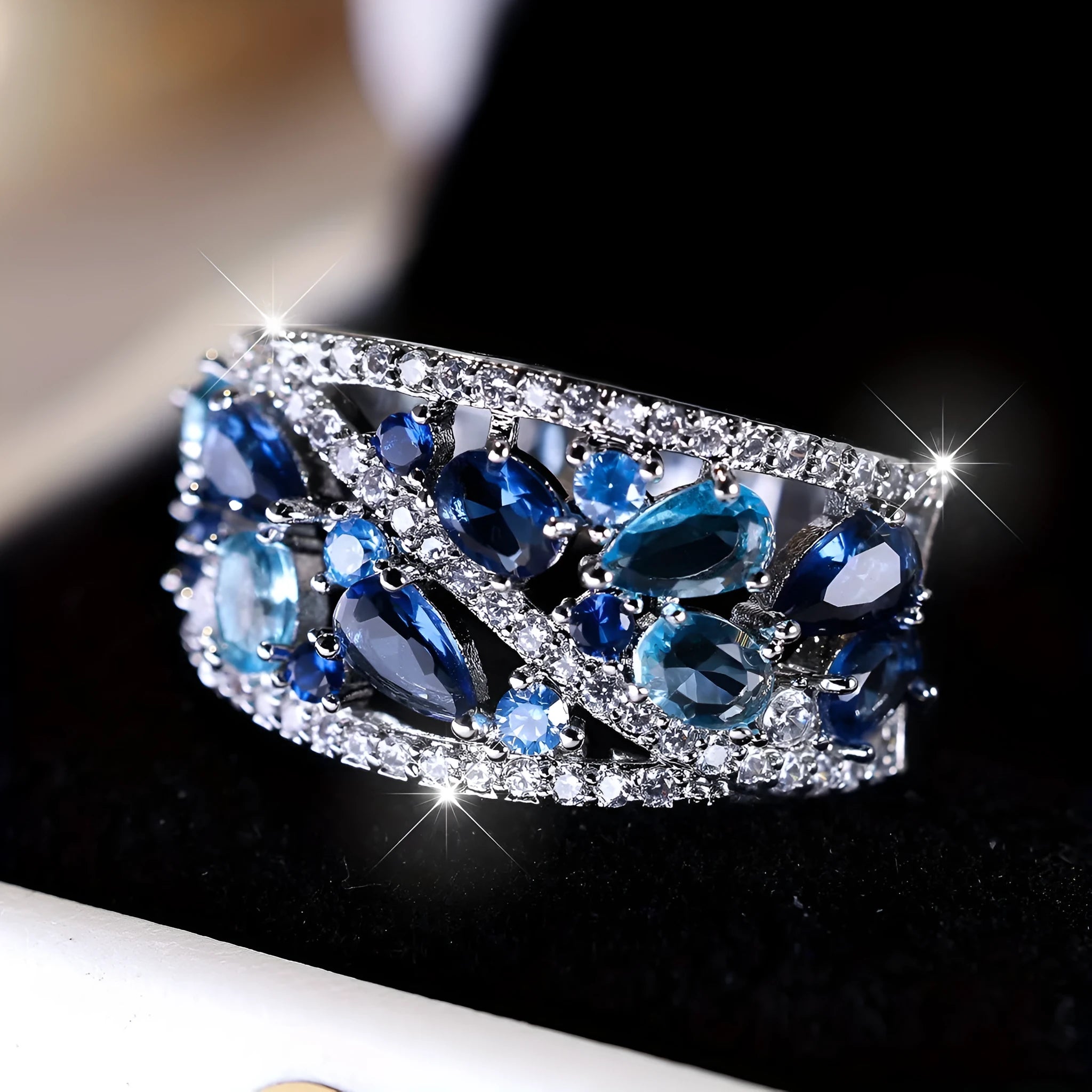 Women's round hollow copper fashion ring with a choice of gemstone colours, shown in gold and platinum finishes.
