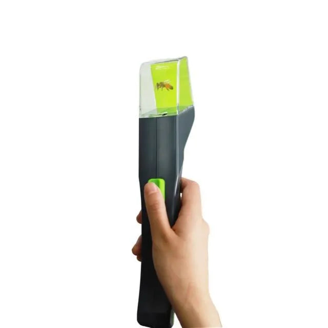 Green handheld plastic insect catcher with soft grip handle for garden pest control