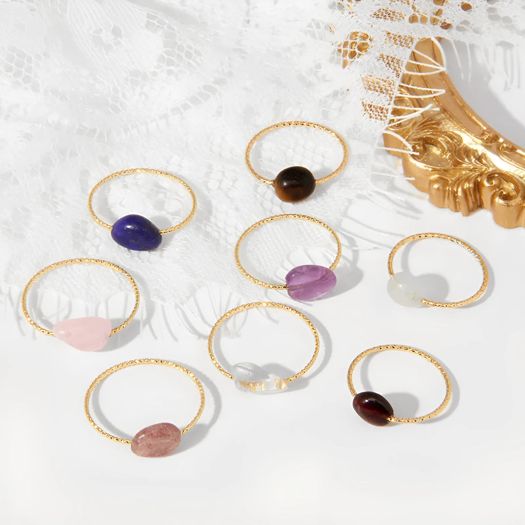 Women's geometric ring with a niche cut in a coloured agate stone on a plain background.