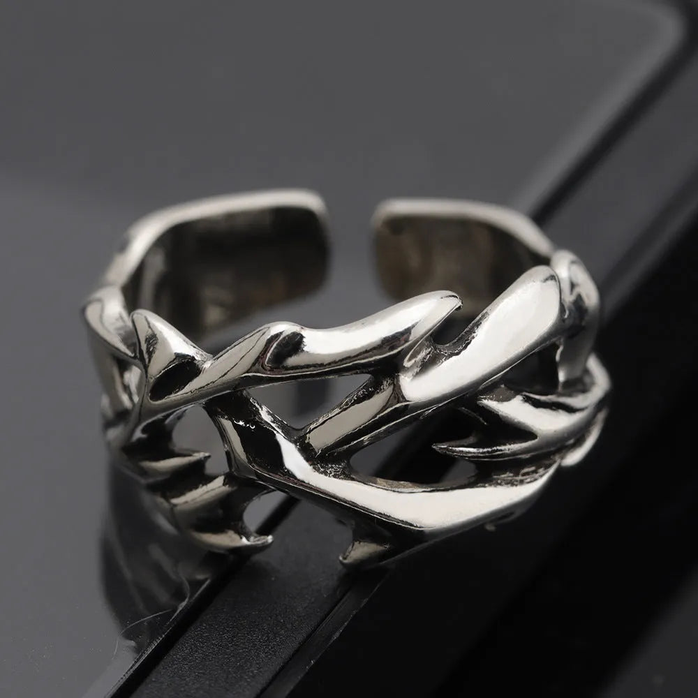 Adjustable copper men's ring with geometric thorn and flower design.