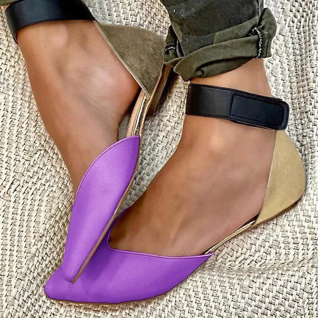Women's beige velcro sandals with a hollowed flat design on a neutral background.