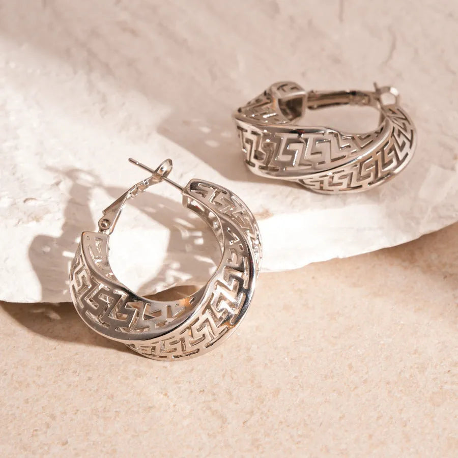 Gold and silver geometric women's hollow stud earrings with a twisted round design.