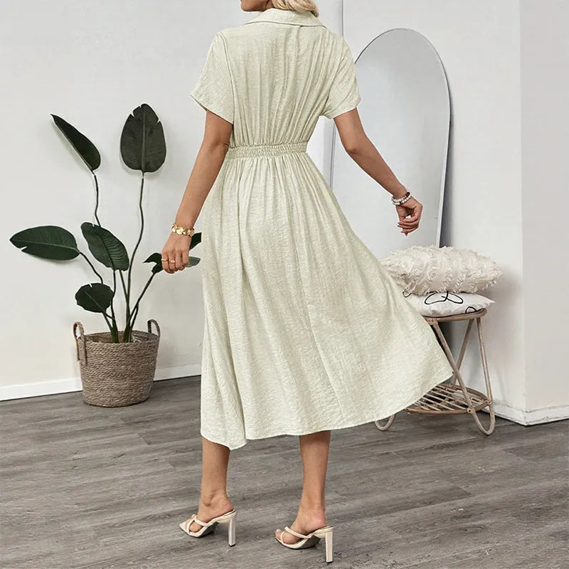 Light green women's lapel collar shirt dress with waist tie and side pockets on a dress form.