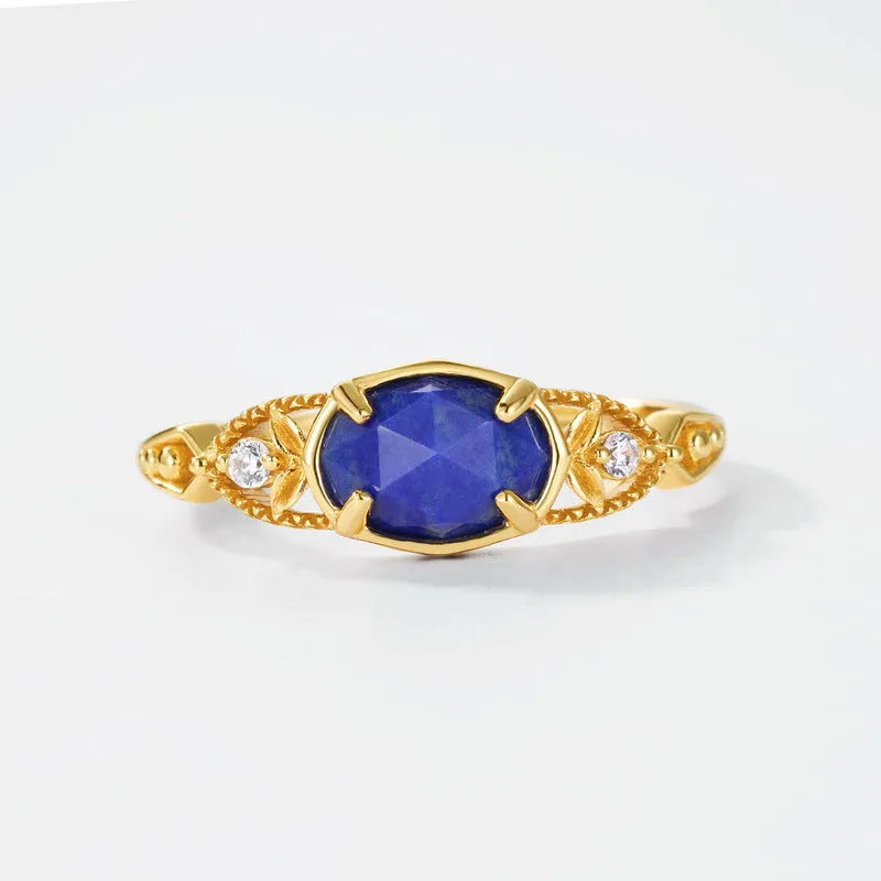 Geometric ellipse silver-colour alloy ring with a central natural lapis lazuli stone.