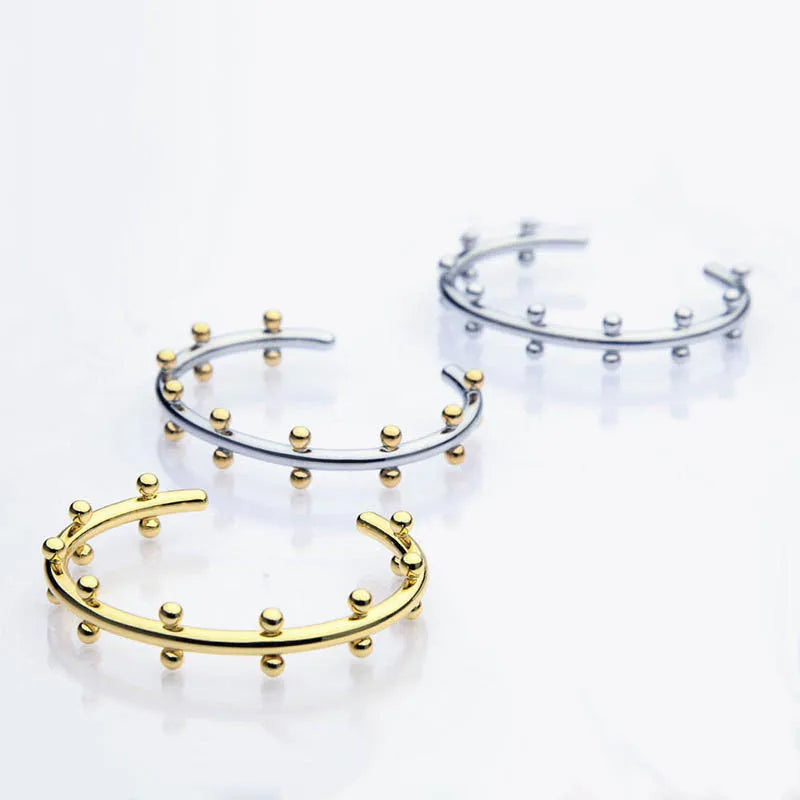 Stainless steel C-shaped texture beads with rivet design in gold, steel, and steel gold finishes