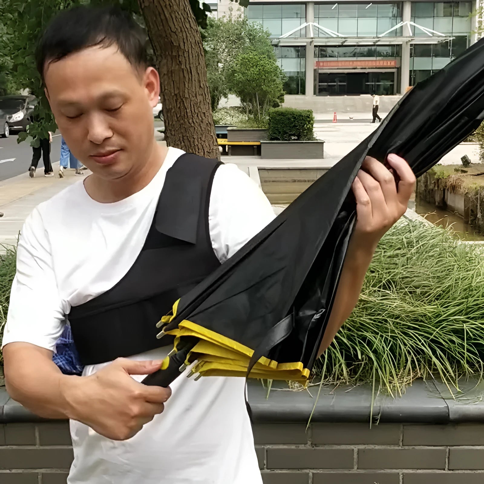 Portable black umbrella holder with shoulder strap showing diving cloth construction and simple design