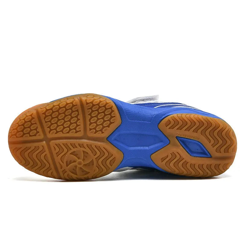 White and blue low-top PVC badminton shoes with round toe and ribbed sole.