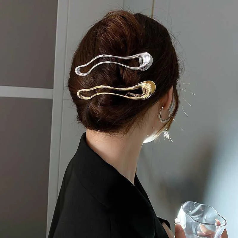 Women's zinc alloy hair barrette in gold or silver with geometric shape options
