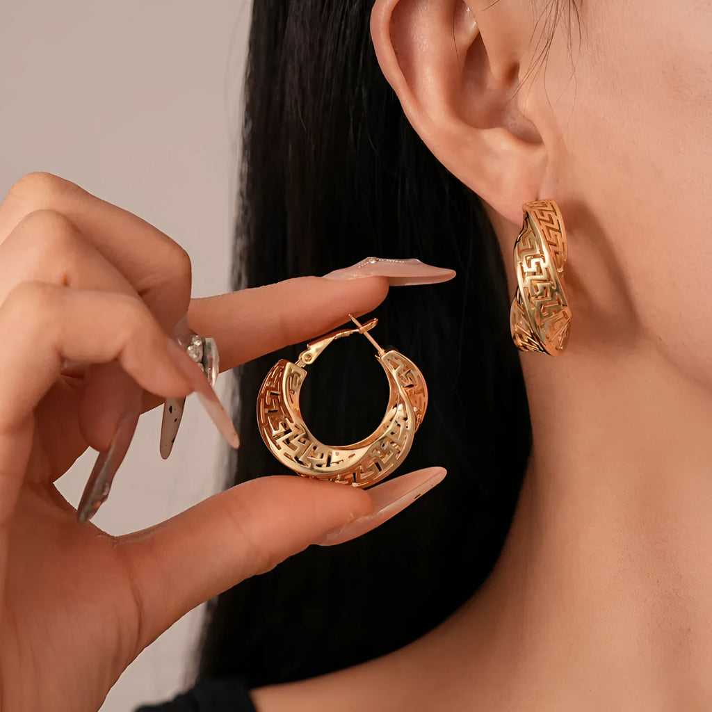 Gold and silver geometric women's hollow stud earrings with a twisted round design.
