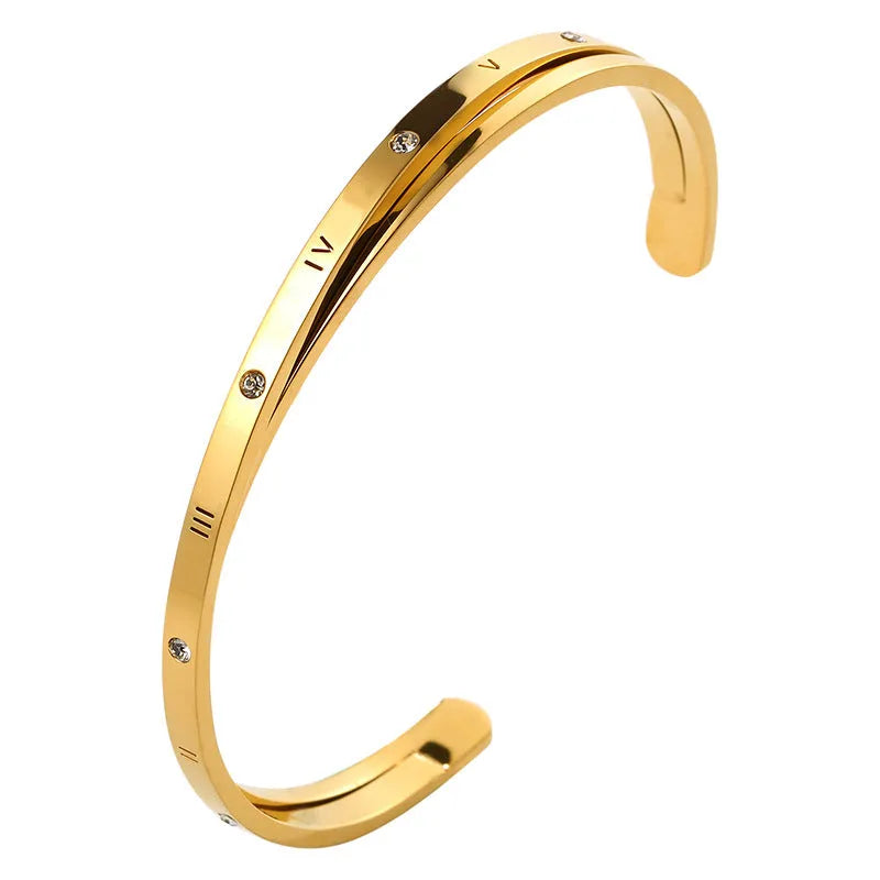 Open-ended stainless steel women's bracelet with zircon stones in rose gold colour.