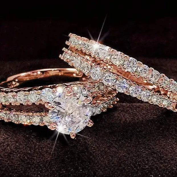 Two-ring women's set showing jewelled and geometric designs in silver, gold, and rose gold alloy