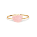 Women's geometric ring with a niche cut in a coloured agate stone on a plain background.