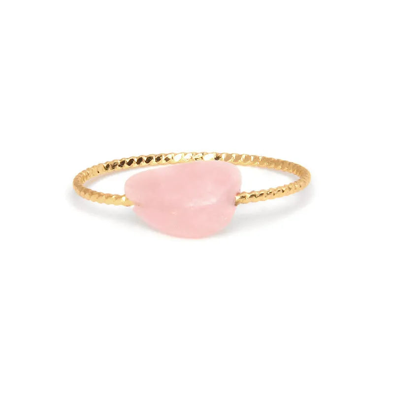 Women's geometric ring with a niche cut in a coloured agate stone on a plain background.