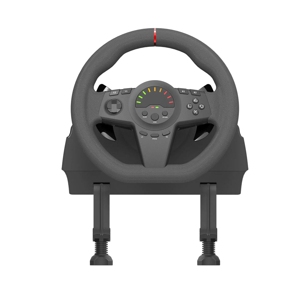 Black multi-platform gaming steering wheel with two pedals and a manual mounting bracket on a desk.
