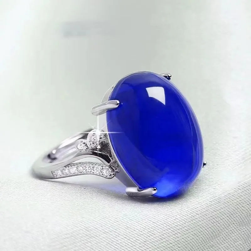 Adjustable geometric alloy ring with ethnic style in blue, shown on a finger.