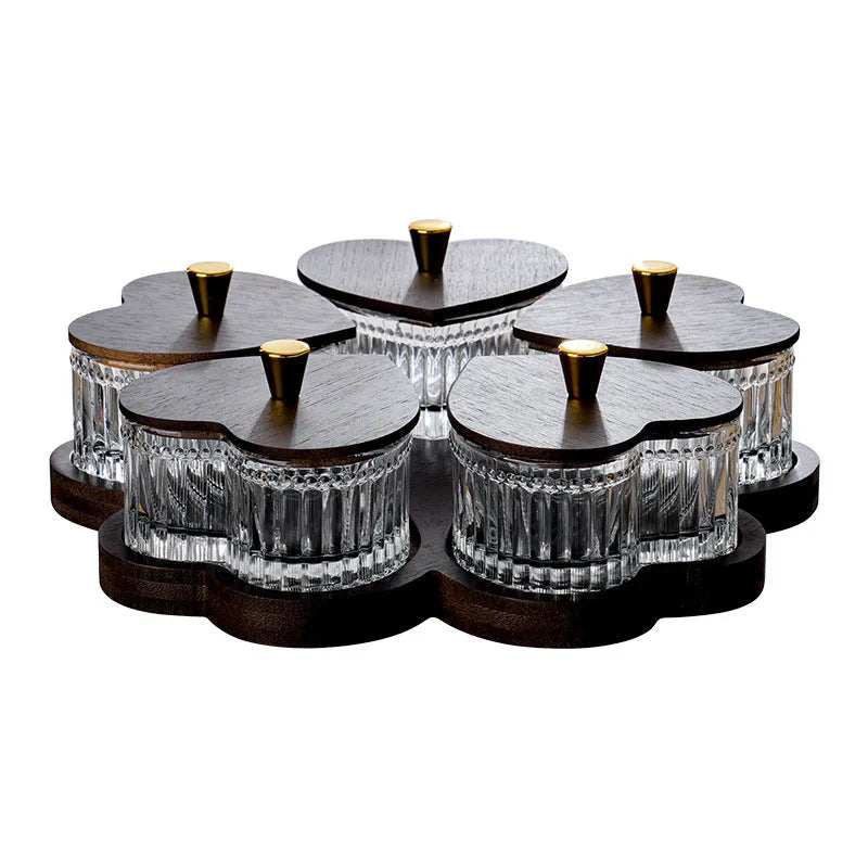 Glass serving platter with heart-shaped transparent lids in a 4-grid configuration on a table.