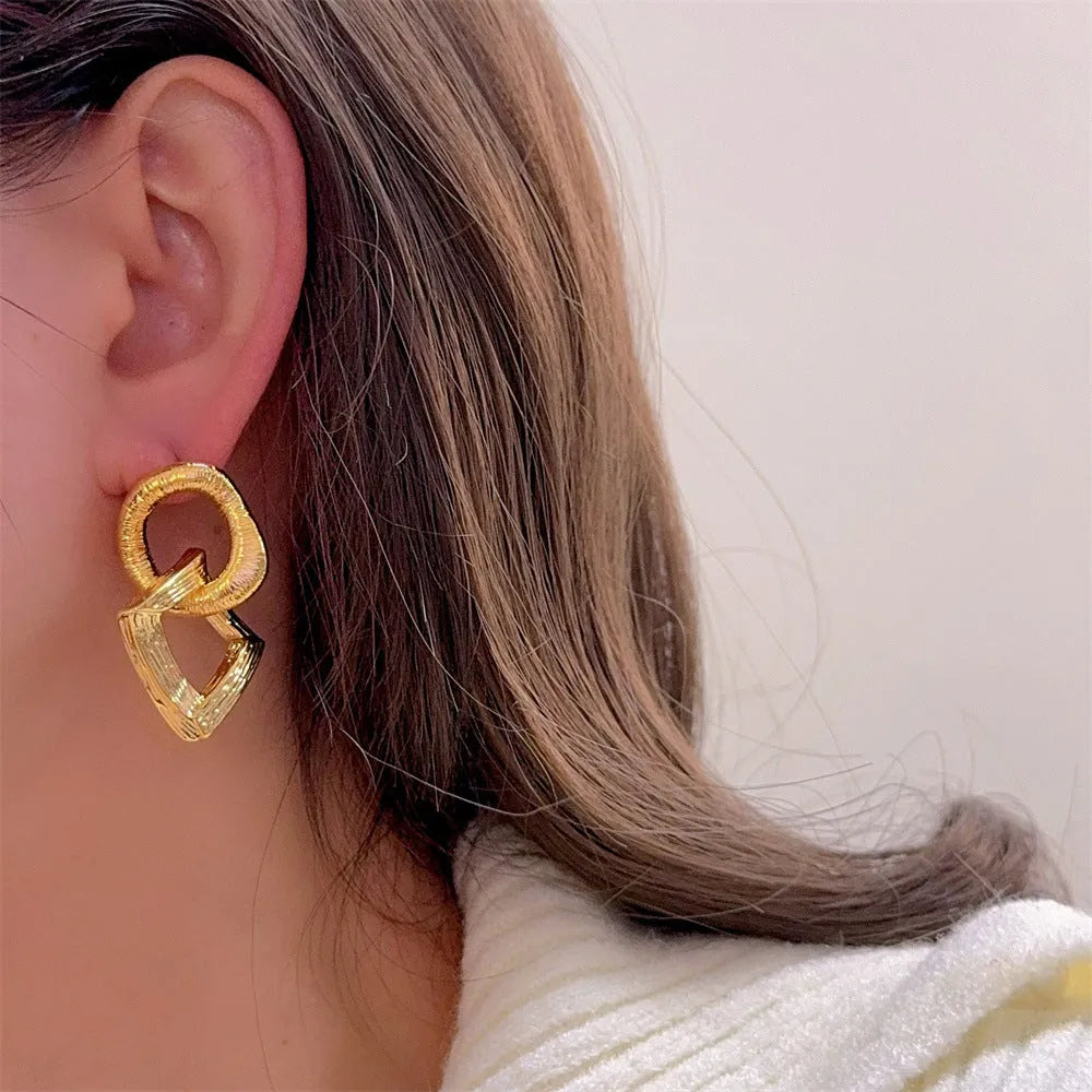 Retro geometric circle pendant earrings in gold or silver, made from copper with a 3.4cm drop.