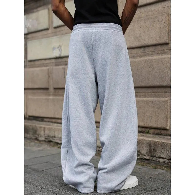 Man wearing dark grey high-waisted straight-leg cropped casual trousers made from bamboo fibre.